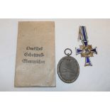 A German Nazi Mother's Cross and a Second War Work Service medal in packet of issue (2)