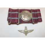 A Parachute Regiment stable belt with Pegasus buckle and a Parachute Regiment cap badge