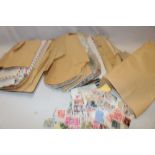 A box containing a selection of various World stamps on/off paper, packets of stamps etc.