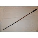 A tribal spear with iron double edged blade and wooden shaft