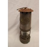 An old brass mounted steel miner's lamp by Thomas and Williams of Aberdare