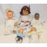 Five various composition dolls in varying sizes