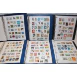 Six folder albums containing a collection of World stamps