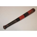 An old turned wood truncheon with black and red striped painted decoration 16" long