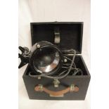 A Naval painted metal hand-held signalling lamp in fitted case