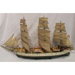 A wood and composition scale built model of a Danish three-masted sailing vessel in full sail with