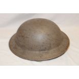 A Second War British painted steel helmet with liner