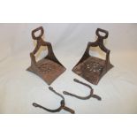 Two similar 18th/19th century South American iron stirrups with pierced decoration and a pair of