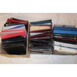 Three boxes containing a large selection of empty stamp albums, stamp catalogues,