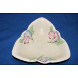 A Clarice Cliff pottery triangular bowl with raised floral decoration 8" wide