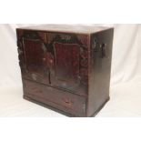 A large 19th century Japanese lacquered table cabinet with an arrangement of seven drawers enclosed