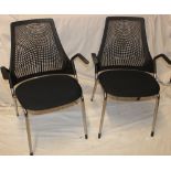 A pair of Herman Miller designed easy chairs with composition net-effect backs and upholstered