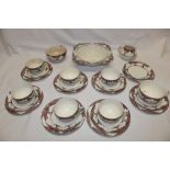 A Crown Ducal part tea set with blossoming tree decoration comprising seven cups, eight saucers,
