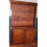 A Victorian mahogany bookcase with cupboard enclosed by two panelled doors,