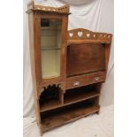 An Edwardian Art Nouveau bureau display cabinet with pigeon holes enclosed by a fall front flanked