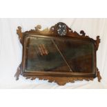 A good quality rectangular wall mirror in carved mahogany scroll frame with bird emblem,