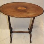 A late Victorian inlaid mahogany oval occasional table on turned and fluted columns with scroll