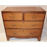 A 19th century oak cross-banded chest of two short and two long drawers with brass ring handles on