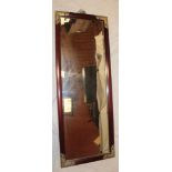 A modern Chinese-style bevelled rectangular wall mirror in brass mounted mahogany frame,