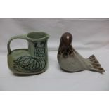 A studio pottery figure of a bird 7" long and one other studio pottery jug with bird decoration (2)