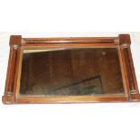 A Victorian rectangular over mantel mirror in polished rosewood and gilt painted frame with column