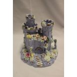 A mauve glazed Staffordshire pottery pastille burner in the form of a castle with raised encrusted