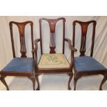 A set of four single and two carver Edwardian inlaid mahogany dining chairs with pierced splat