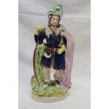 A Victorian Staffordshire pottery figure of a traveller with cloak,