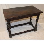 An old oak rectangular occasional table on turned tapered legs,