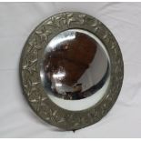 A convex circular wall mirror in pewter mounted circular frame decorated in relief with leaves,