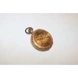 A ladies 18ct gold fob watch with decorated circular dial in engraved case