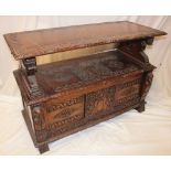 A 1930's/40's carved oak rectangular monks bench with swivelling top/back and box seat with