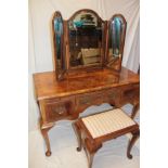 A 1930's/40's figured walnut rectangular side table/dressing table with three drawers in the frieze
