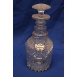 A 19th century cut-glass triple ring neck decanter and stopper with ceramic sherry label,