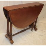 A Victorian walnut oval Sutherland-style drop-leaf tea table on turned supports with castors