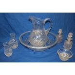 An unusual cut-glass jug and bowl set comprising circular wash bowl, tapered jug, pair of decanters,
