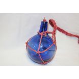 An old blue tinted glass spherical hand-thrown fire extinguishing grenade