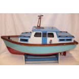 An old wooden scale built model cabin cruiser with period motor 33" long