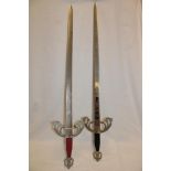Two Spanish copy medieval-style swords with decorated blades and ornate hilts