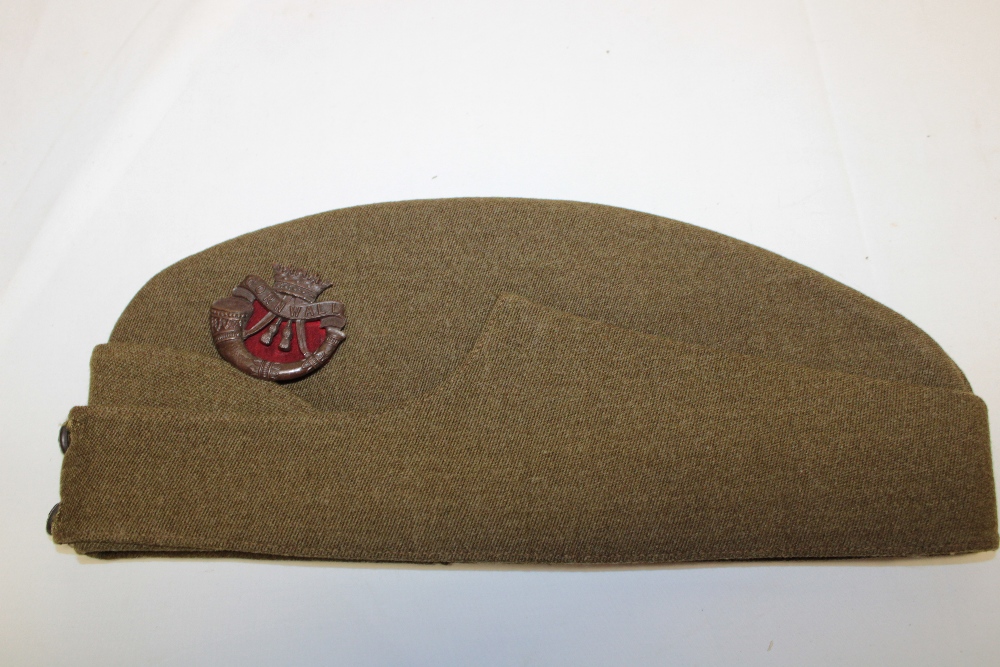 An Officer's khaki side hat of the Duke of Cornwall's Light Infantry with bronze DCLI cap badge