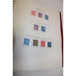 A printed album containing a collection of Guernsey stamps 1958-1990