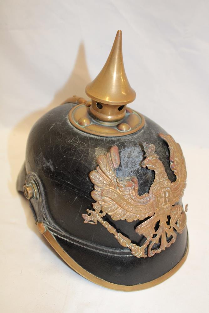 A First War Imperial German black leather pickelhaube helmet with brass mounts,