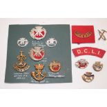 A selection of DCLI military badges and insignia including brass Field Service cap badge 1896-1900,