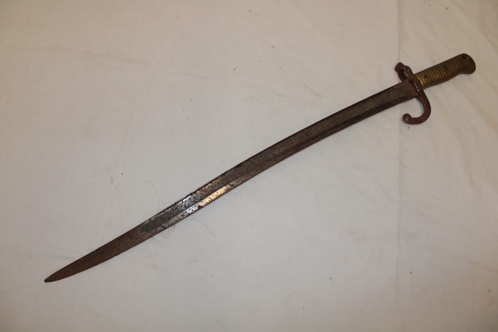 A 19th century French Chassepot bayonet with curved single edged blade and brass mounted hilt