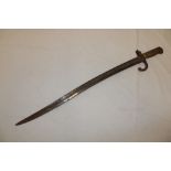 A 19th century French Chassepot bayonet with curved single edged blade and brass mounted hilt