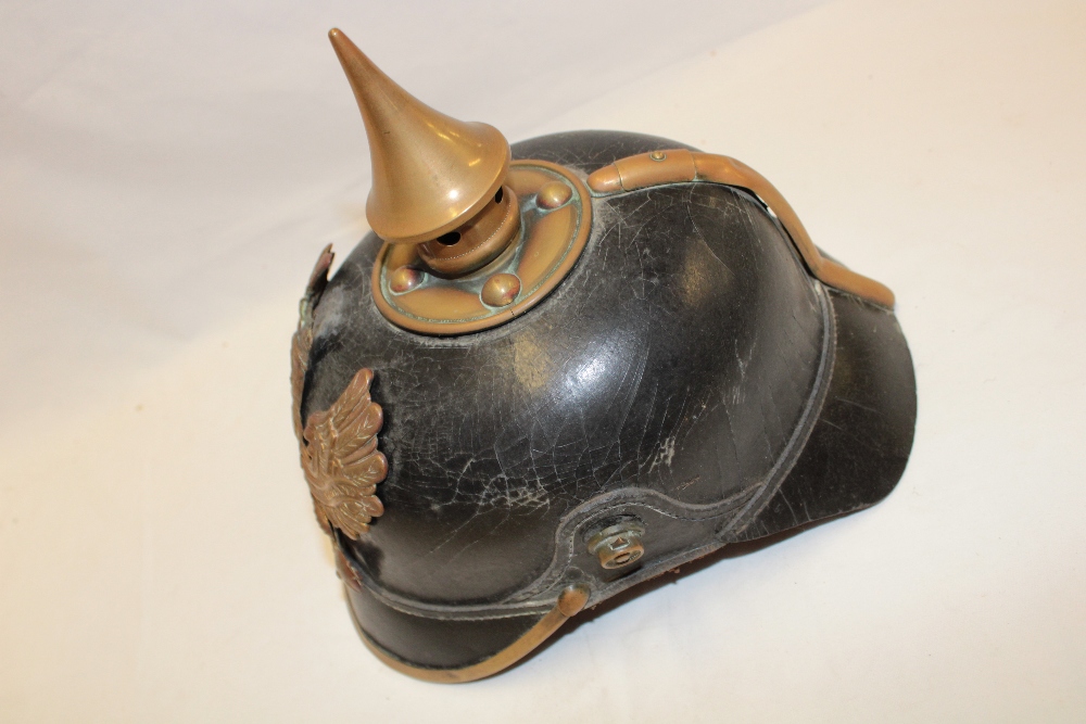 A First War Imperial German black leather pickelhaube helmet with brass mounts, - Image 2 of 3