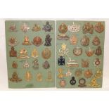 Two cards containing a collection of various Military cap badges including Johore Volunteers,