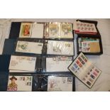 Four albums containing a selection of GB and World first day covers, PHQ cards,