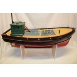 A wooden scale built model fishing boat with period internal motor 31" long