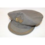A Portuguese Air Force grey cloth peaked cap with embroidered badge and peak